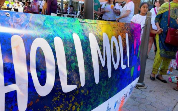 People covered in colored paint at Holi Moli