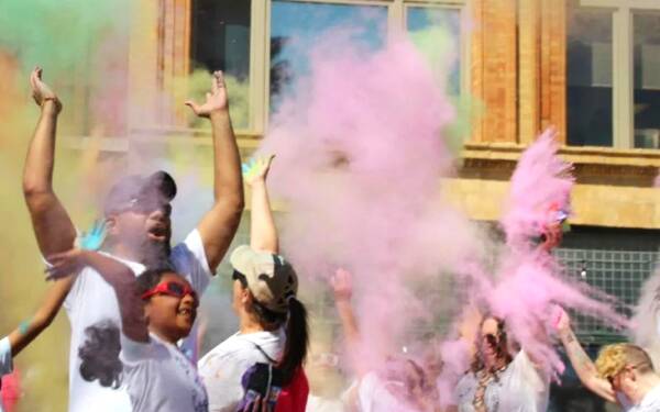 People covered in colored paint at Holi Moli
