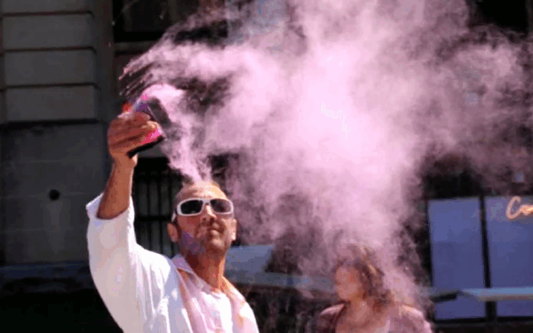 People covered in colored paint at Holi Moli